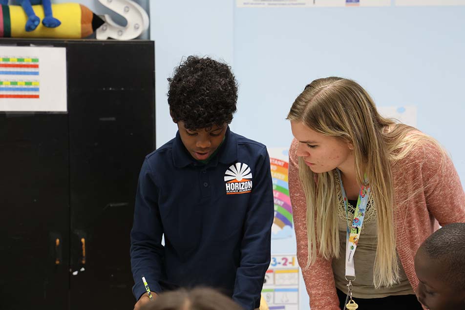students and teacher working in classroom