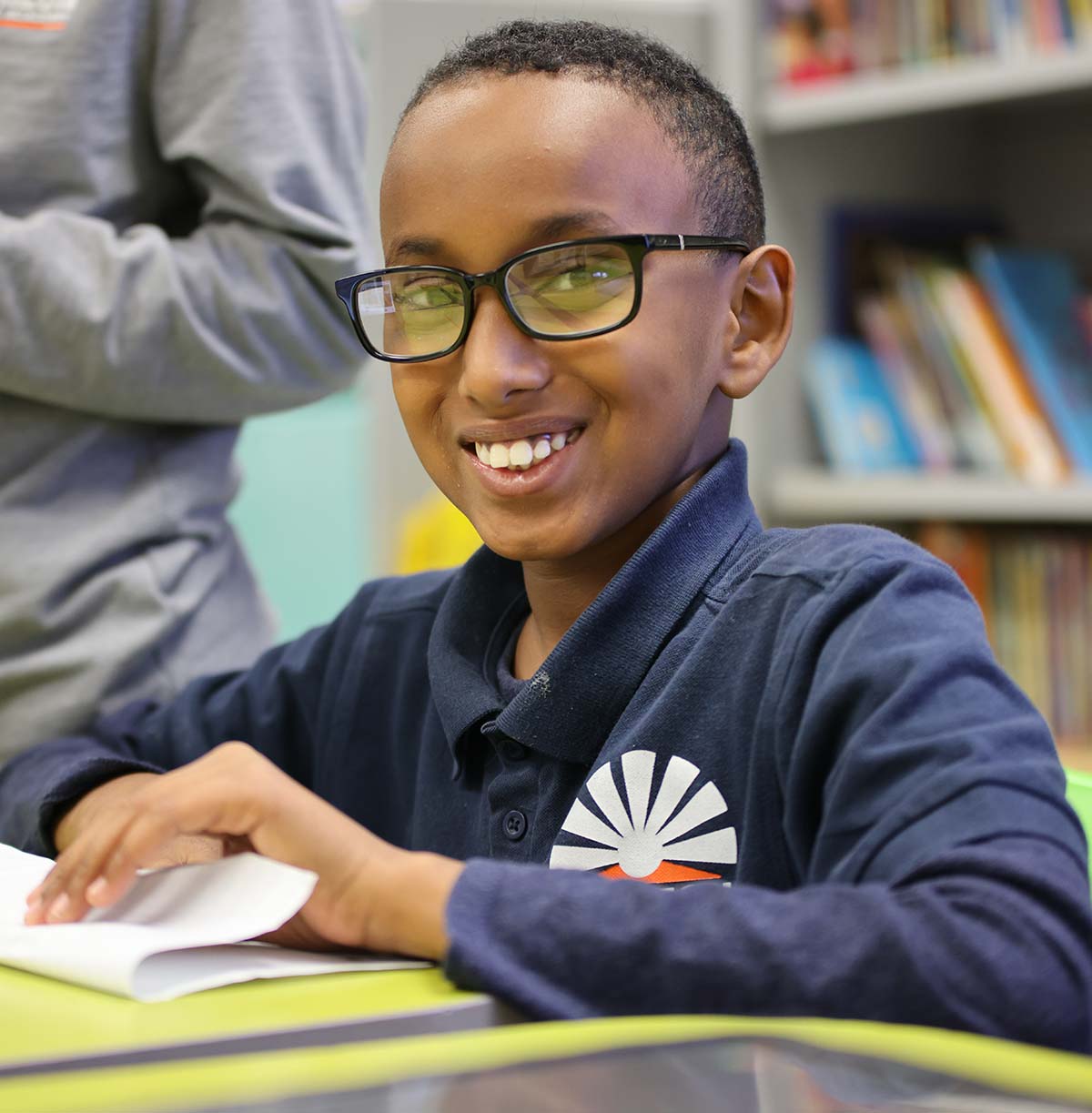Student drawing in a classroom.